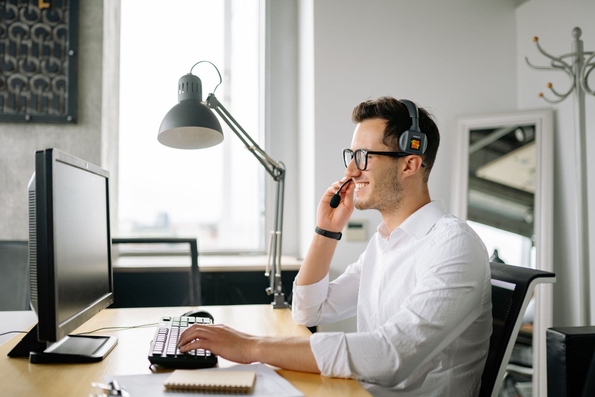 Professional wearing a headset while attending an online training session